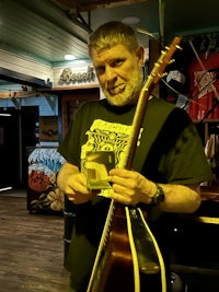 a man holding a guitar in a store